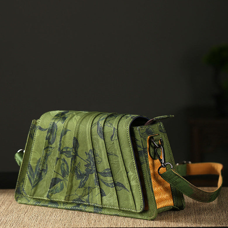 Green floral-patterned bag with a brown interior on a dark background