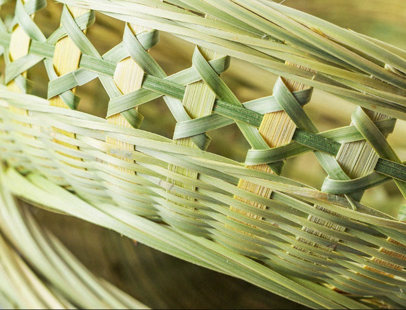 Close-up of a woven basket with green bamboo strips