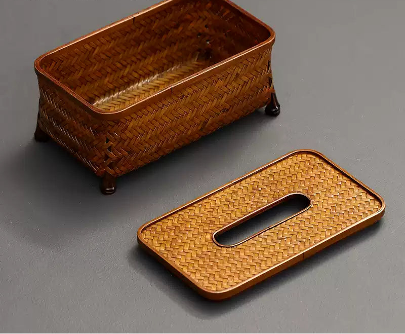 Woven brown tissue holder on a gray background