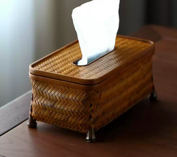 Woven tissue box on a wooden surface with a blurred background